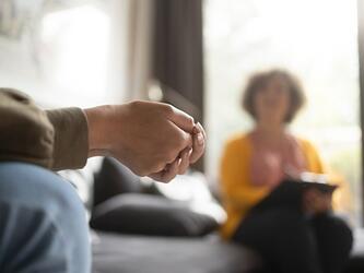 blurred photo of two people having a difficult conversation, with one taking notes